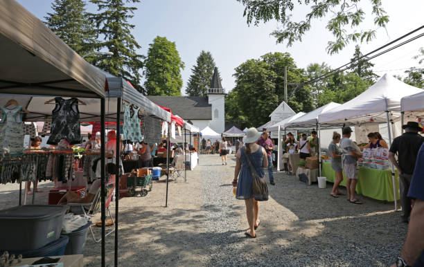 Placeholder photo of a community farmers market with vendor tents and shoppers browsing